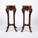 A pair of Chinese hardwood stands circa 1900 each with inset white marble tops, 81cm high