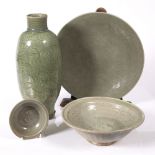 A Chinese celadon sleeve vase Ming period 37.5cm high with trailing foliage, two celadon bowls and a