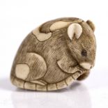 A Japanese ivory netsuke of a pie-bald rat 19th Century squatting holding its tail, inlaid eyes