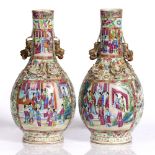 A pair of Chinese Canton bottle vases 19th Century each painted with polychrome enamels, interior