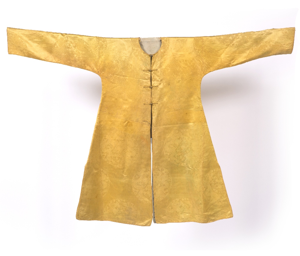 A Tibetan lama's robe circa 1800 yellow silk damask with roundels having five clawed dragons chasing