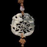 A Chinese pierced and carved translucent and opaque agate pendant in the form of phoenix, with agate