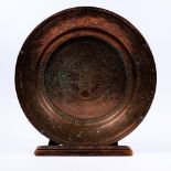 An Indian copper charger circa 1900 engraved with foliate designs, 38cm