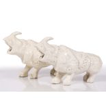 A pair of Chinese white glazed models of rhinoceroses 19th Century 23cm long x 15cm high