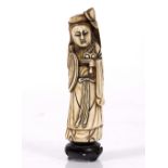 A Chinese ivory tusk end figure of Ho Sien-Ku 19th Century standing holding a ling chi fungus