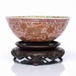 A Chinese porcelain bowl decorated on the exterior with gilt and rouge-de-fer with four phoenix on a