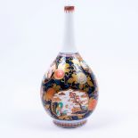 A Japanese Imari bottle vase early 20th Century with panels of landscape scenes on a cobalt