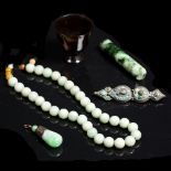 A group of Chinese pieces to include a jade necklace, a turquoise brooch, an agate small wine cup