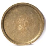 A Qajar engraved brass round tray (Qalamzani) decorated with a foliage, flower and geometrical
