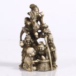 A Japanese ivory okimono carved as a pyramid depicting the Shichifukin late Meiji each with their