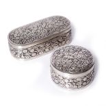 Two white metal boxes India,circa 1900 one of oval form with trailing fruit and a matching