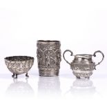 Three pieces of white metal Burmese, 19th century to include a beaker decorated with six figures