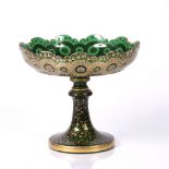 Green glass tazza Bohemian, 19th Century having gilt foliate designs 22cm across, 20cm high