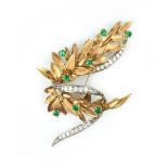 AN EMERALD AND DIAMOND SPRAY BROOCH, the stylised foliate spray accented with circular mixed-cut