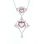 AN EARLY 20TH CENTURY RUBY AND DIAMOND PENDANT NECKLACE, comprising two openwork cartouche panels,