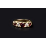 A GARNET AND DIAMOND FIVE STONE RING, alternately inset with circular mixed-cut garnets and round