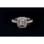 A DIAMOND CLUSTER RING, centred with a pierced rectangular cluster of baguette and round brilliant-