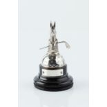 A SILVER GOLF TROPHY, modelled as a rabbit holding a golf club upon a domed half golf ball, by