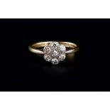 A DIAMOND FLOWERHEAD CLUSTER RING, the graduated old brilliant and single-cut diamonds in millegrain