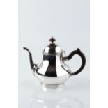 A CONTEMPORARY CHANNEL ISLANDS SILVER TEAPOT, of baluster design, with wooden handle and knop by