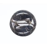 A PISCES PANEL BROOCH BY H G MURPHY FOR THE FALCON STUDIO, the circular panel with pierced and