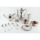 A LATE VICTORIAN SILVER PLATED TEA AND COFFEE POT, with matching milk jug, a pair of bottle coasters