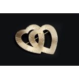 A DOUBLE HEARTS BROOCH BY TIFFANY & CO, designed as two entwined openwork hearts with engraved