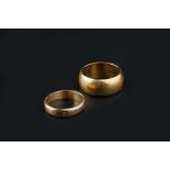 TWO WEDDING BANDS, comprising a 22ct gold wide wedding band, hallmarked for Birmingham 1908, and