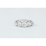 A DIAMOND FIVE STONE RING, the graduated cushion-shaped old-cut diamonds in claw setting, white
