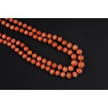 A DOUBLE STRAND CORAL BEAD NECKLACE, comprising two strands of graduated coral corallium rubrum