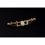 AN OPAL BAR BROOCH, the oval cabochon opal claw set to a shaped openwork bar with scrolled