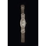 A LADY'S DIAMOND SET COCKTAIL WATCH, the shaped silvered dial with stylised Arabic numerals and