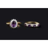 TWO AMETHYST AND DIAMOND DRESS RINGS, comprising a cluster ring, the oval mixed-cut amethyst claw