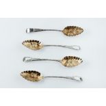 A SET OF FOUR GEORGE III SILVER GILT BERRY SPOONS later embossed and engraved with fruit and