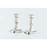 A PAIR OF EARLY 20TH CENTURY SILVER CANDLESTICKS, with knopped and half lobed columns, on