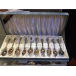 A SET OF TWELVE CHINESE WHITE METAL COFFEE SPOONS, with cabochon jade inset terminals, cased; a