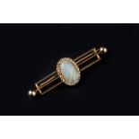 AN OPAL AND DIAMOND CLUSTER BAR BROOCH, the oval cabochon opal collet set within a border of rose