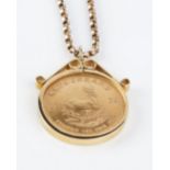 A KRUGERRAND PENDANT ON CHAIN, the krugerrand coin dated 1973, loose mounted in 9ct gold pendant