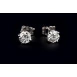 A PAIR OF DIAMOND SINGLE STONE EAR STUDS, each round brilliant-cut diamond in four claw setting,