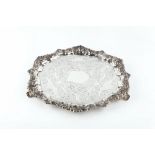 A LATE VICTORIAN SILVER SALVER, with engraved foliate and 'C' scroll decoration, within a foliate