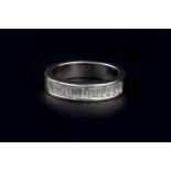 A DIAMOND HALF HOOP RING, the line of baguette-cut diamonds in channel setting, 18ct white gold