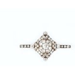 A DIAMOND PANEL BROOCH, centred with a cluster of graduated cushion-shaped old-cut diamonds, to an