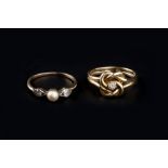 TWO DIAMOND SET RINGS, the first a late Victorian dress ring, of knot-shaped design with reeded