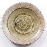 Phil Rogers (b.1951) Charger green glaze, incised motif within combed pattern rim impressed potter's