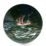 Jonathan Chiswell Jones (b.1944) 'Boat on Silver Sea' bowl on green lustre ground painted potter's