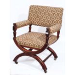 A LATE VICTORIAN WALNUT FRAMED ARMCHAIR with inverted hoop and turned stretcher support on