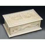 A LATE 19TH/EARLY 20TH CENTURY INDIAN IVORY RECTANGULAR CASKET, the cover carved with two