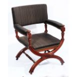 A LATE VICTORIAN OAK FRAMED ELBOW CHAIR with inverted hoop supports and ring turned stretchers,