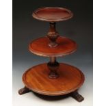 AN EDWARDIAN MAHOGANY MINIATURE DUMB WAITER of graduated three tier form with baluster column and