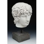 A WHITE COMPOSITION HEAD of a classical boy after the Antique on plinth, 48cm high